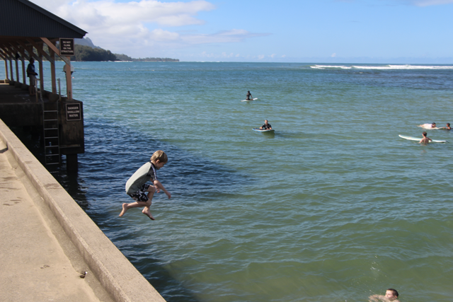 Action shot, mid-jump off the pier.